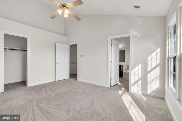 unfurnished bedroom featuring multiple windows, visible vents, and light colored carpet