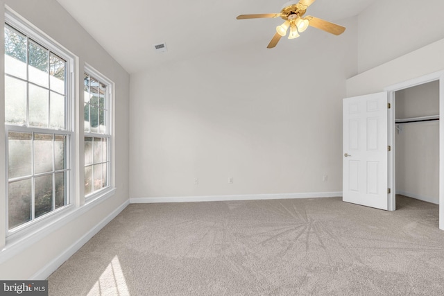 unfurnished bedroom featuring carpet floors, visible vents, a ceiling fan, baseboards, and a closet