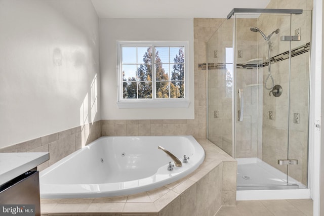 bathroom featuring a garden tub, a shower stall, tile patterned flooring, and vanity