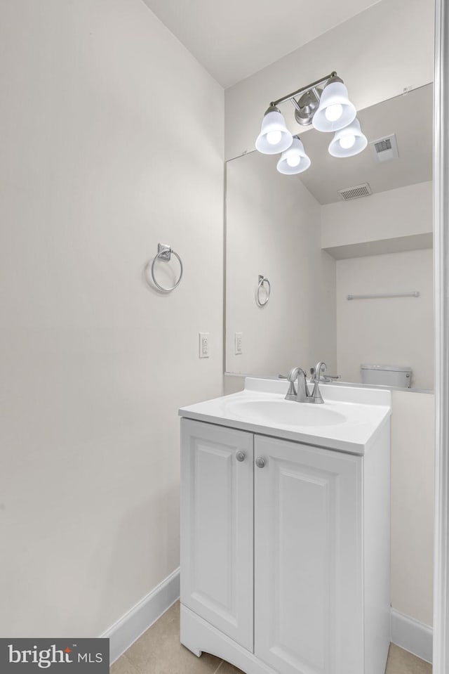 bathroom featuring toilet, baseboards, visible vents, and vanity