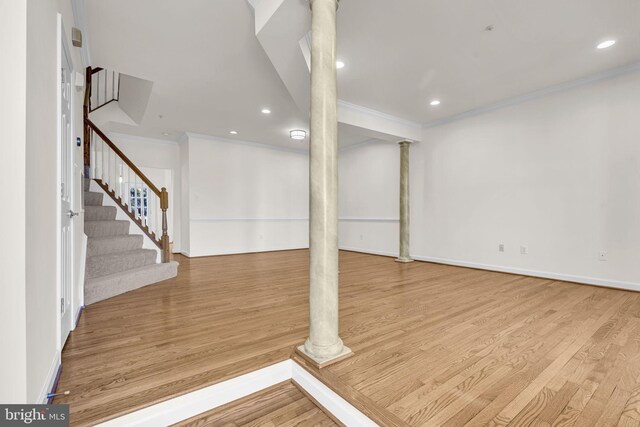 below grade area featuring stairway, recessed lighting, ornamental molding, and light wood-style flooring