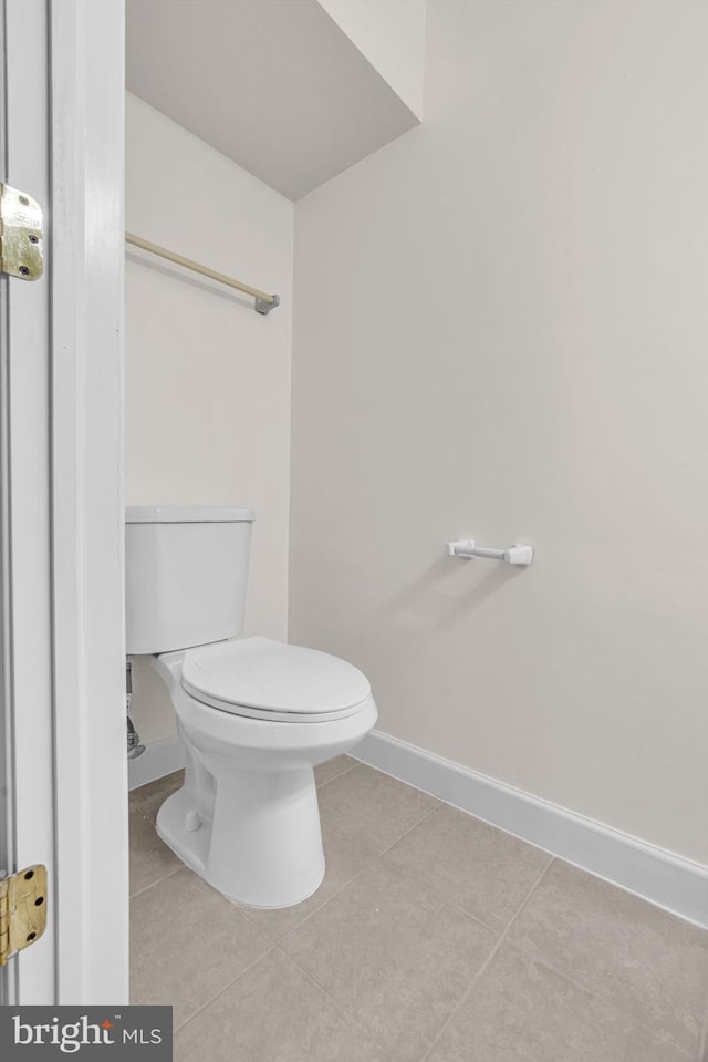 bathroom with tile patterned flooring, toilet, and baseboards