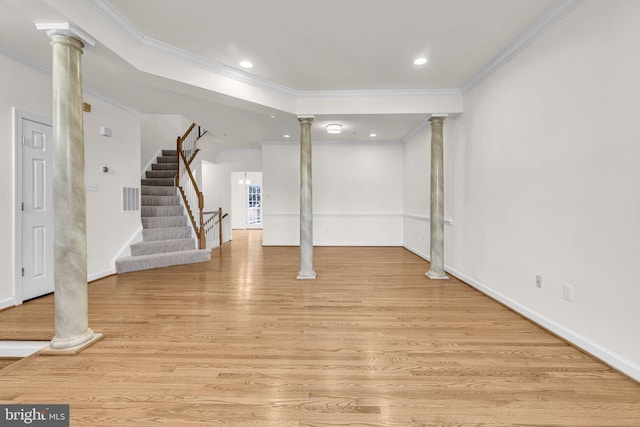 below grade area with stairs, ornamental molding, light wood-type flooring, and visible vents