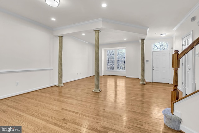 entrance foyer with crown molding, decorative columns, light wood-type flooring, baseboards, and stairs