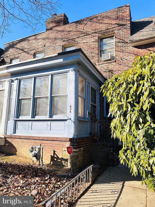 view of side of property with brick siding