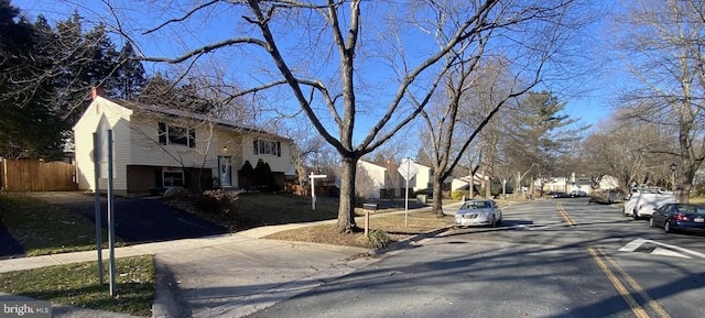 view of street with a residential view, curbs, and sidewalks