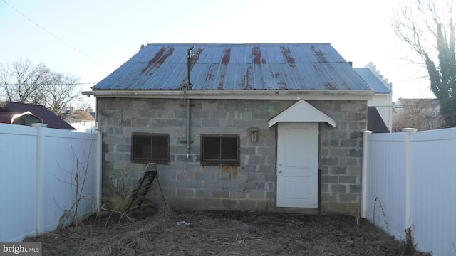 view of outbuilding featuring fence