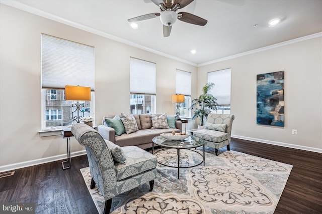 living room with baseboards, ornamental molding, and wood finished floors