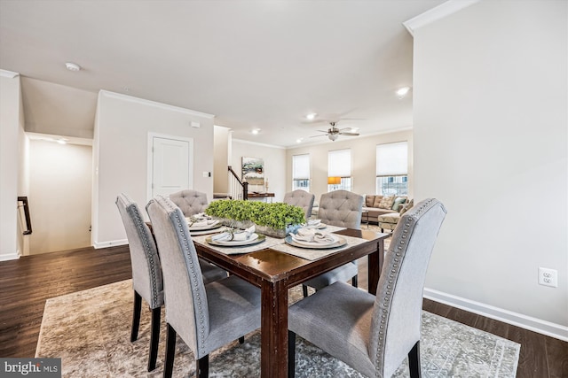 dining area featuring dark wood-style floors, stairway, baseboards, and crown molding