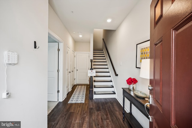 interior space featuring stairs, baseboards, dark wood-type flooring, and recessed lighting