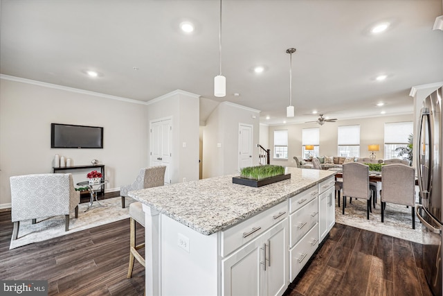 kitchen with dark wood-style floors, freestanding refrigerator, open floor plan, white cabinets, and a kitchen island