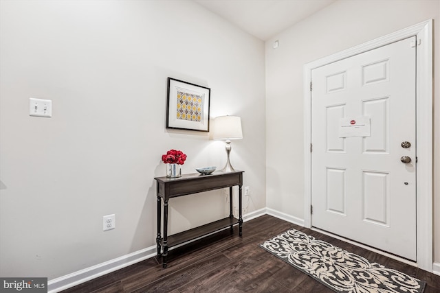 entryway featuring baseboards and wood finished floors