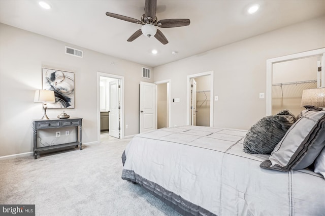 bedroom featuring light carpet, a spacious closet, visible vents, and recessed lighting