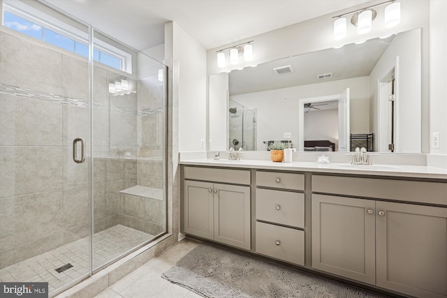 bathroom with a stall shower, visible vents, a sink, and double vanity