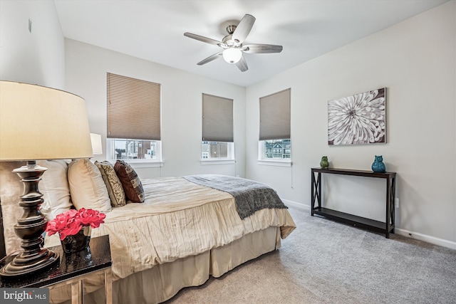 bedroom with multiple windows, baseboards, and carpet flooring