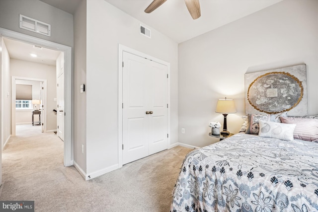 bedroom with light carpet, visible vents, and baseboards