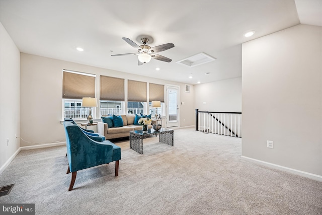 living area with carpet floors, attic access, visible vents, and recessed lighting