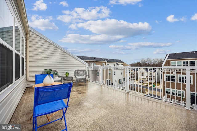 view of patio featuring a balcony and a residential view