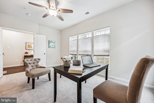 office space featuring visible vents, baseboards, and a ceiling fan