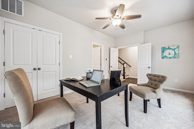 office with ceiling fan, carpet floors, visible vents, and baseboards