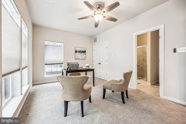 carpeted office featuring a ceiling fan, visible vents, and baseboards