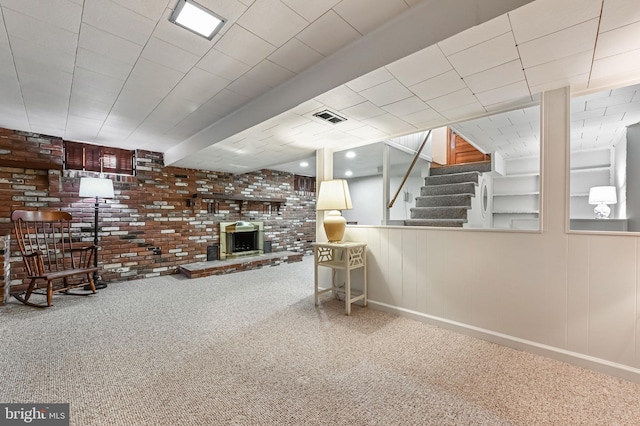 interior space featuring stairway, brick wall, visible vents, and carpet floors