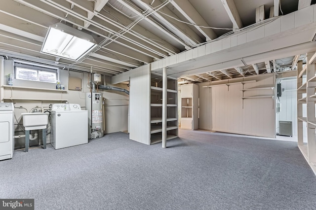 basement with gas water heater, separate washer and dryer, and a sink