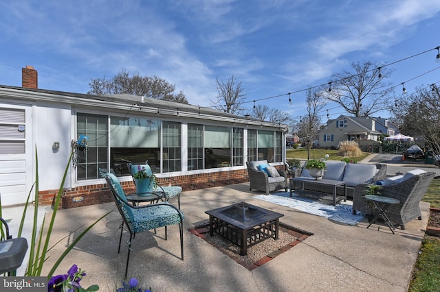 view of patio / terrace featuring an outdoor living space with a fire pit