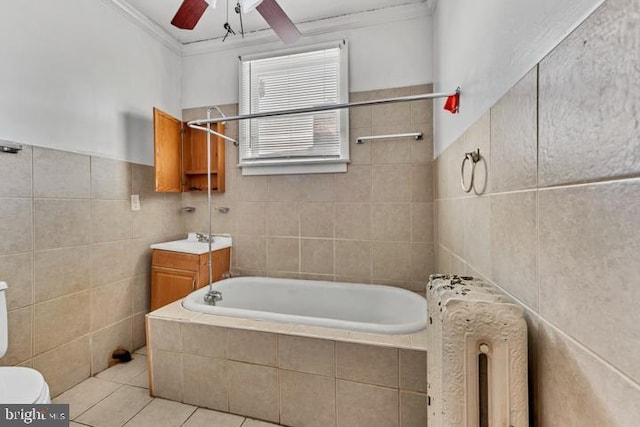 bathroom featuring a relaxing tiled tub, crown molding, tile walls, and tile patterned floors