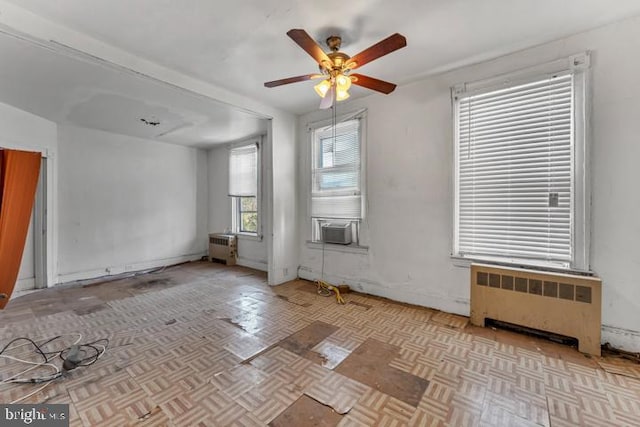 empty room with radiator and a ceiling fan