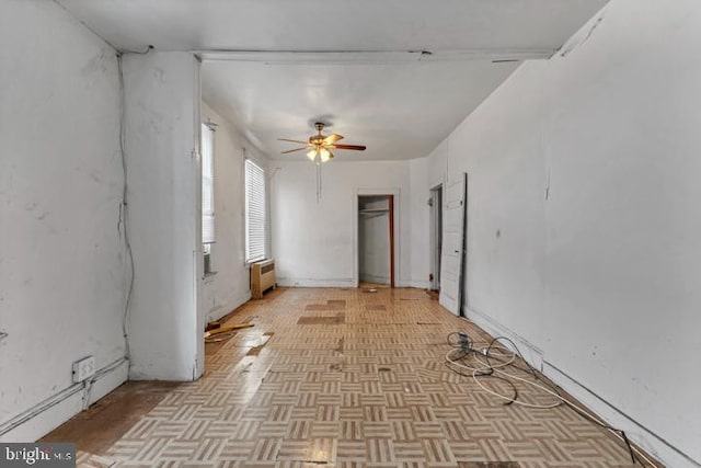 spare room featuring radiator heating unit, a baseboard radiator, and a ceiling fan