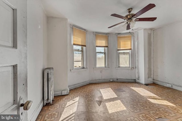 spare room with a ceiling fan and tile patterned floors