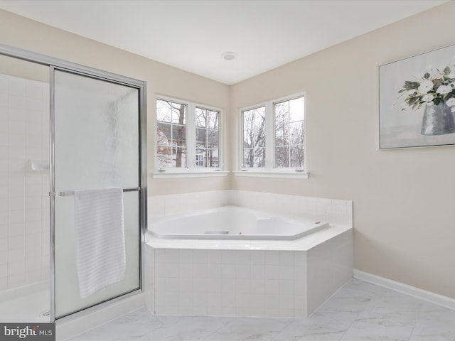 full bathroom featuring marble finish floor, a shower stall, baseboards, and a bath