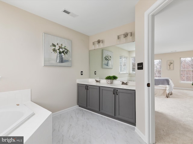 ensuite bathroom featuring double vanity, visible vents, connected bathroom, marble finish floor, and a sink