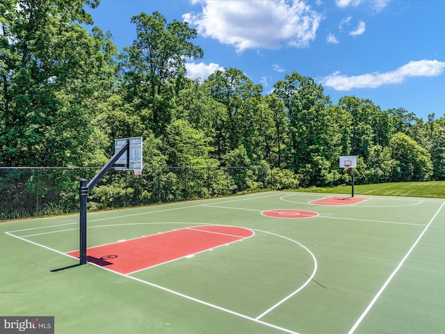 view of basketball court featuring community basketball court and fence