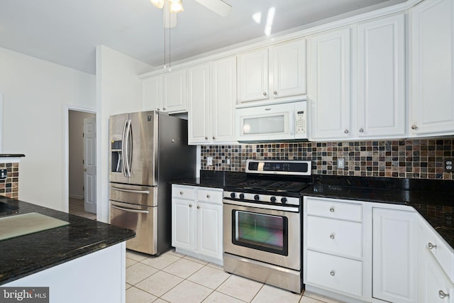 kitchen with appliances with stainless steel finishes, white cabinets, backsplash, and light tile patterned floors