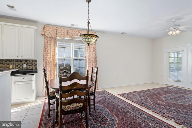 dining space featuring light tile patterned floors, visible vents, and a ceiling fan