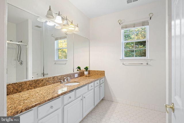 full bathroom with visible vents, an enclosed shower, vanity, tile patterned flooring, and baseboards