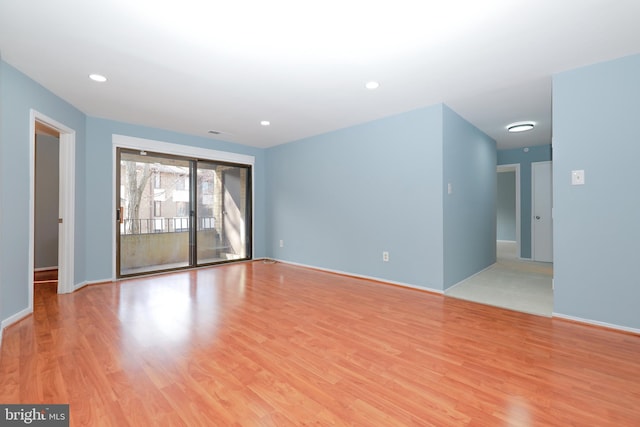 spare room with light wood-style flooring, baseboards, and recessed lighting