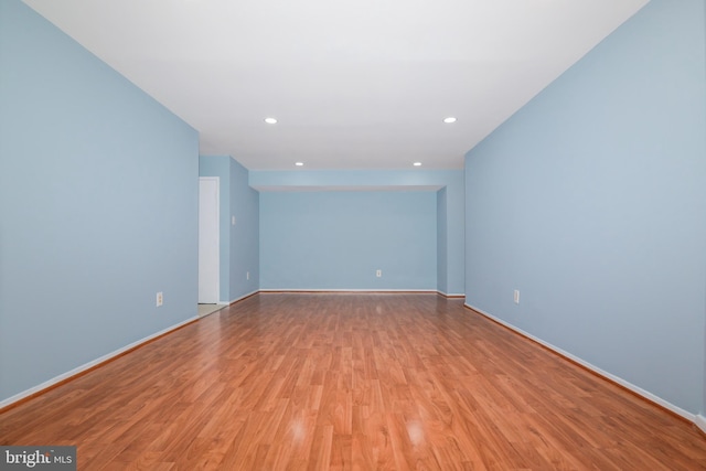 unfurnished room with baseboards, light wood-style flooring, and recessed lighting