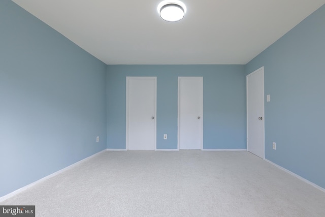 unfurnished bedroom featuring carpet and baseboards