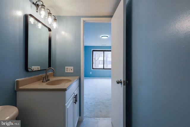 bathroom with toilet and vanity