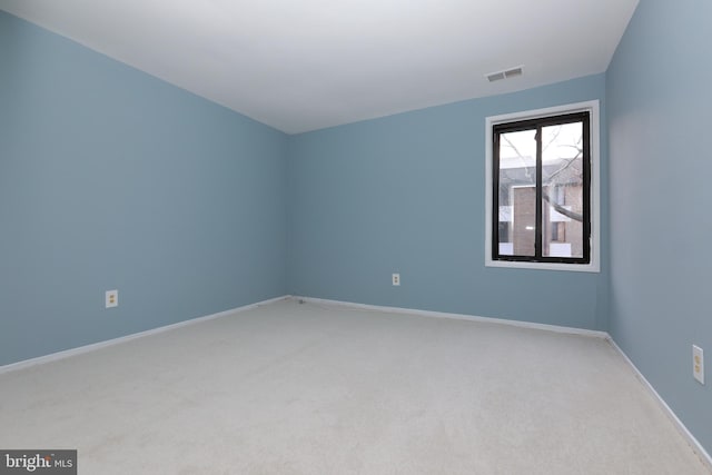 unfurnished room with baseboards, visible vents, and light colored carpet