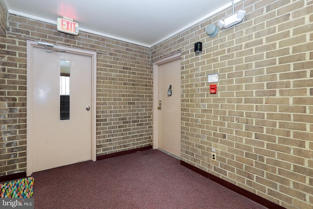 unfurnished room featuring dark colored carpet