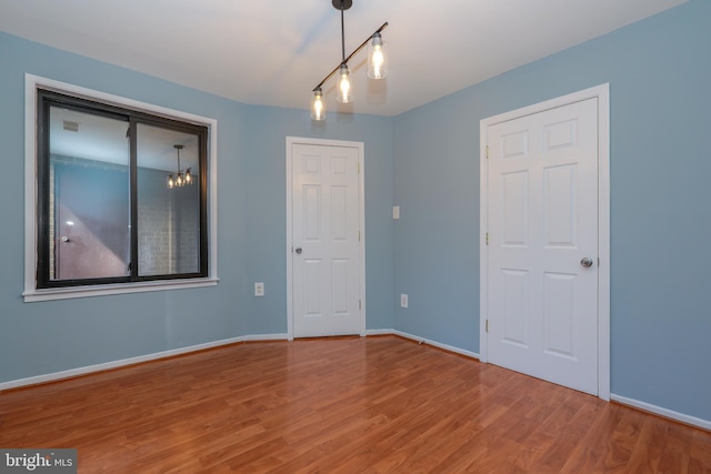 empty room featuring baseboards and wood finished floors