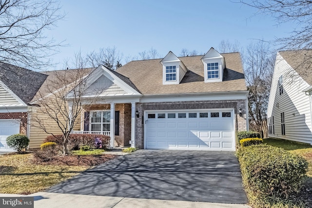 view of front facade featuring an attached garage, roof with shingles, aphalt driveway, and brick siding