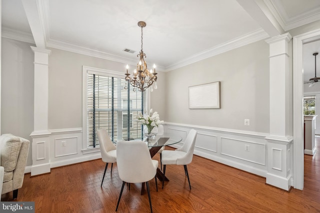 dining space featuring plenty of natural light, wood finished floors, and decorative columns