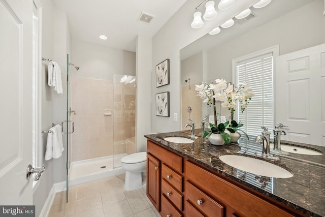 full bathroom featuring a stall shower, tile patterned flooring, and a sink