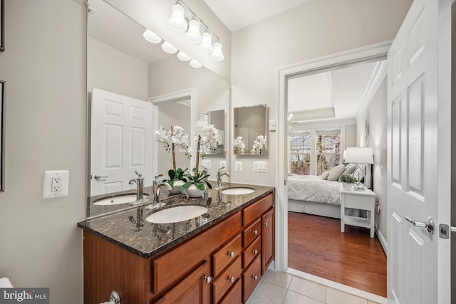 bathroom featuring double vanity, a sink, and ensuite bathroom