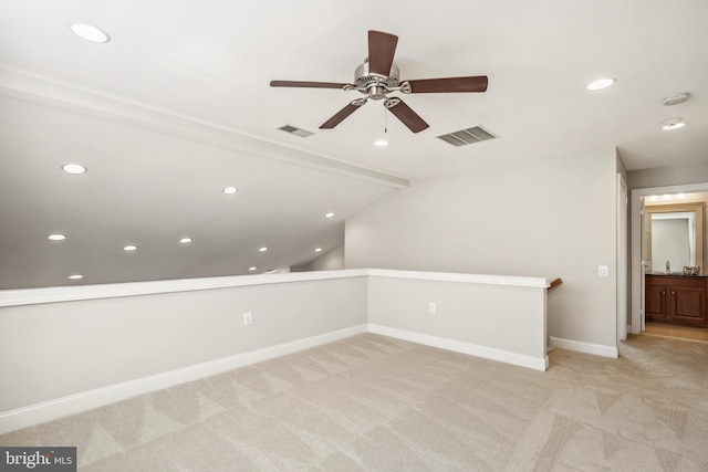 additional living space with light carpet, baseboards, and visible vents